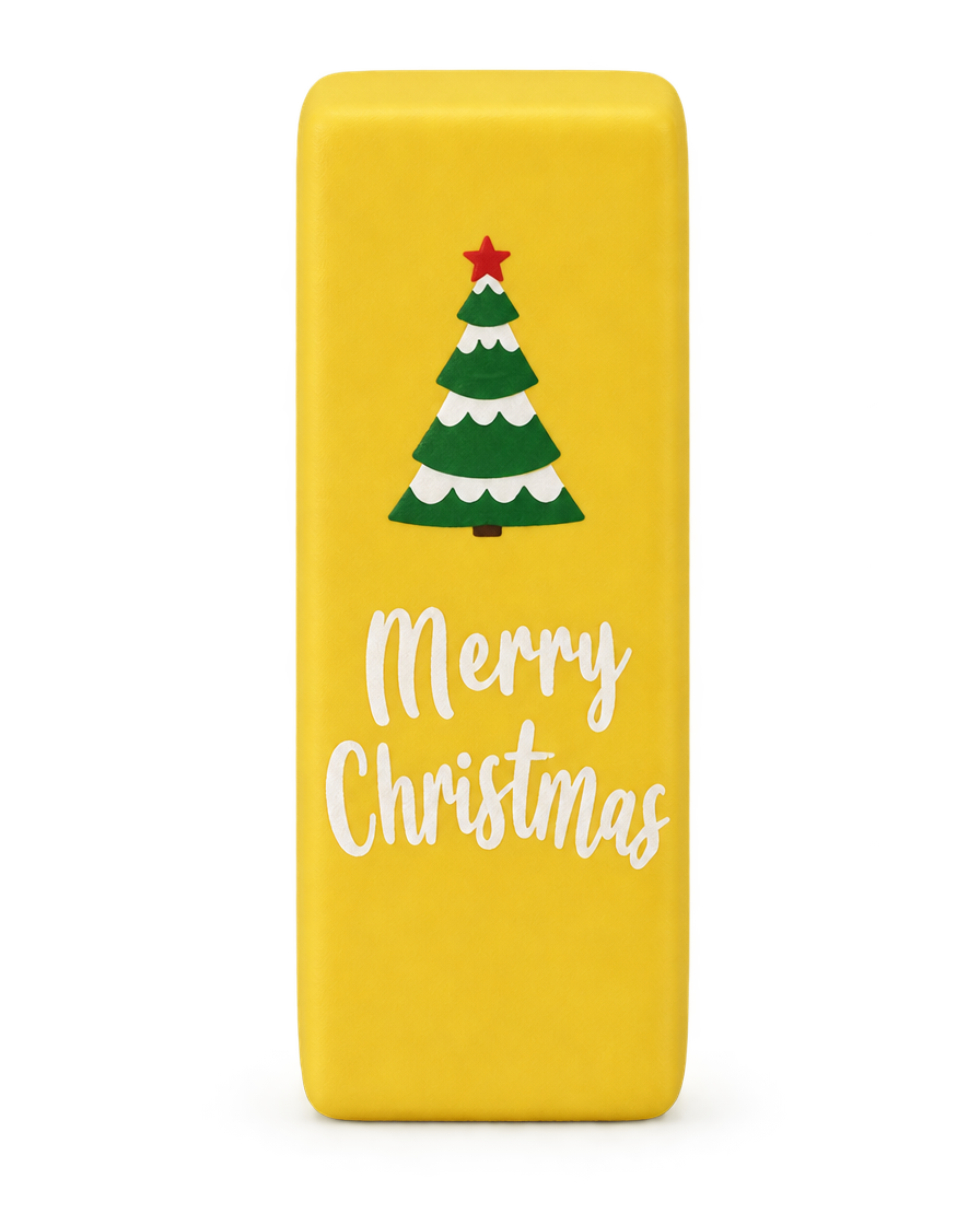 Butter yellow Christmas squishy brick with a Christmas tree and Merry Christmas print, standing upright