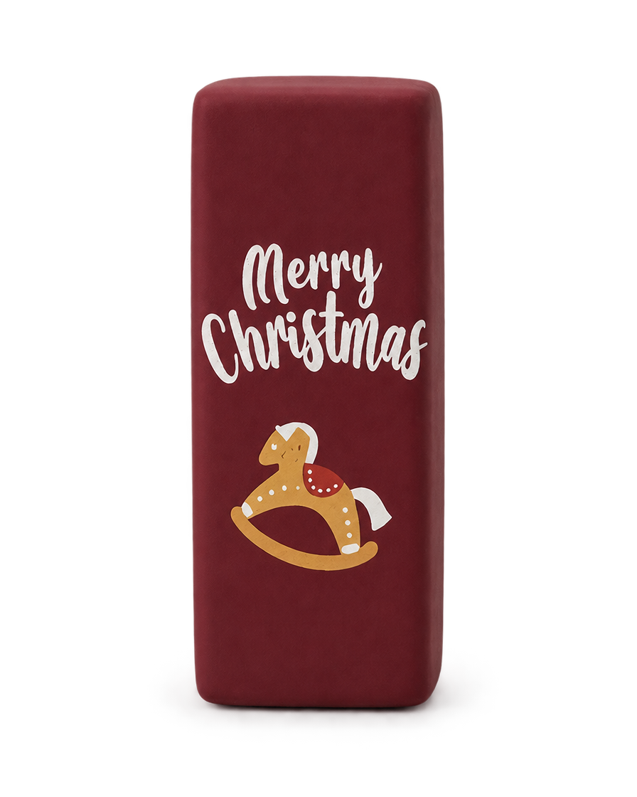 Wine red Christmas squishy brick with a rocking horse and Merry Christmas print, standing upright